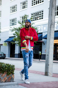 Front view of the 1K Spectrum men's red suede bomber jacket showing the vibrant rainbow trim and premium material