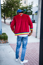 Back view of the 1K Spectrum red suede jacket highlighting the rainbow hem and signature logo detail