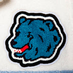 Macro shot showing the detailed embroidery of the blue grizzly bear patch