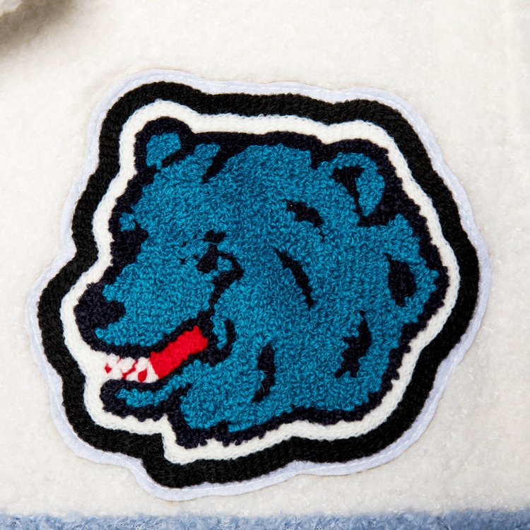 Macro shot showing the detailed embroidery of the blue grizzly bear patch