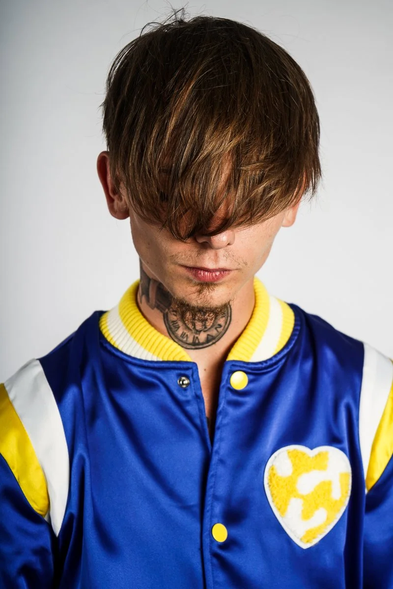 Back and side profile of the royal blue satin jacket showing the yellow and white arm stripes